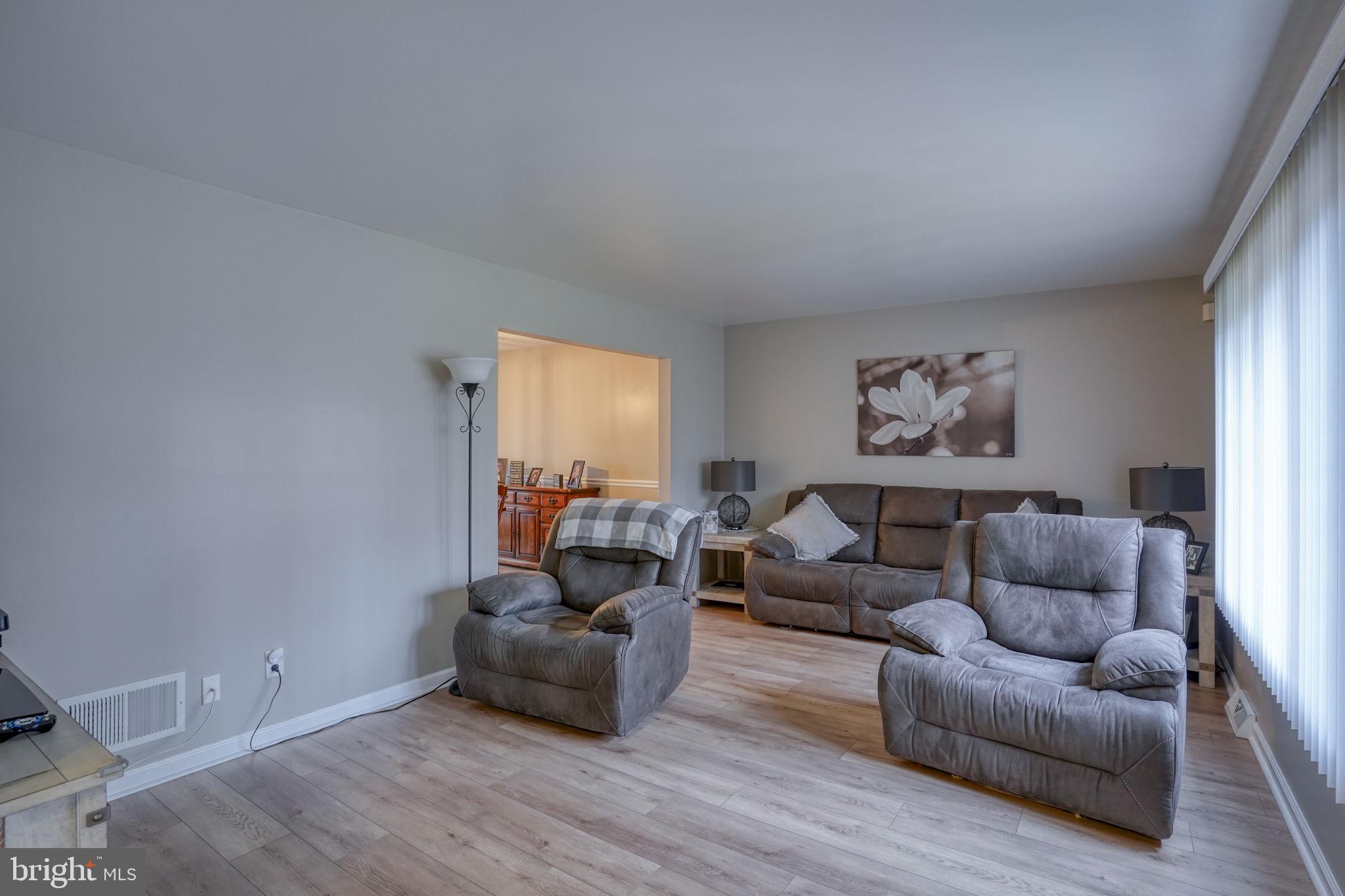 3850 Naamans Creek Road Upper Chichester, PA 19061 - Photo 6 of 53 a living room with furniture and a wooden floor