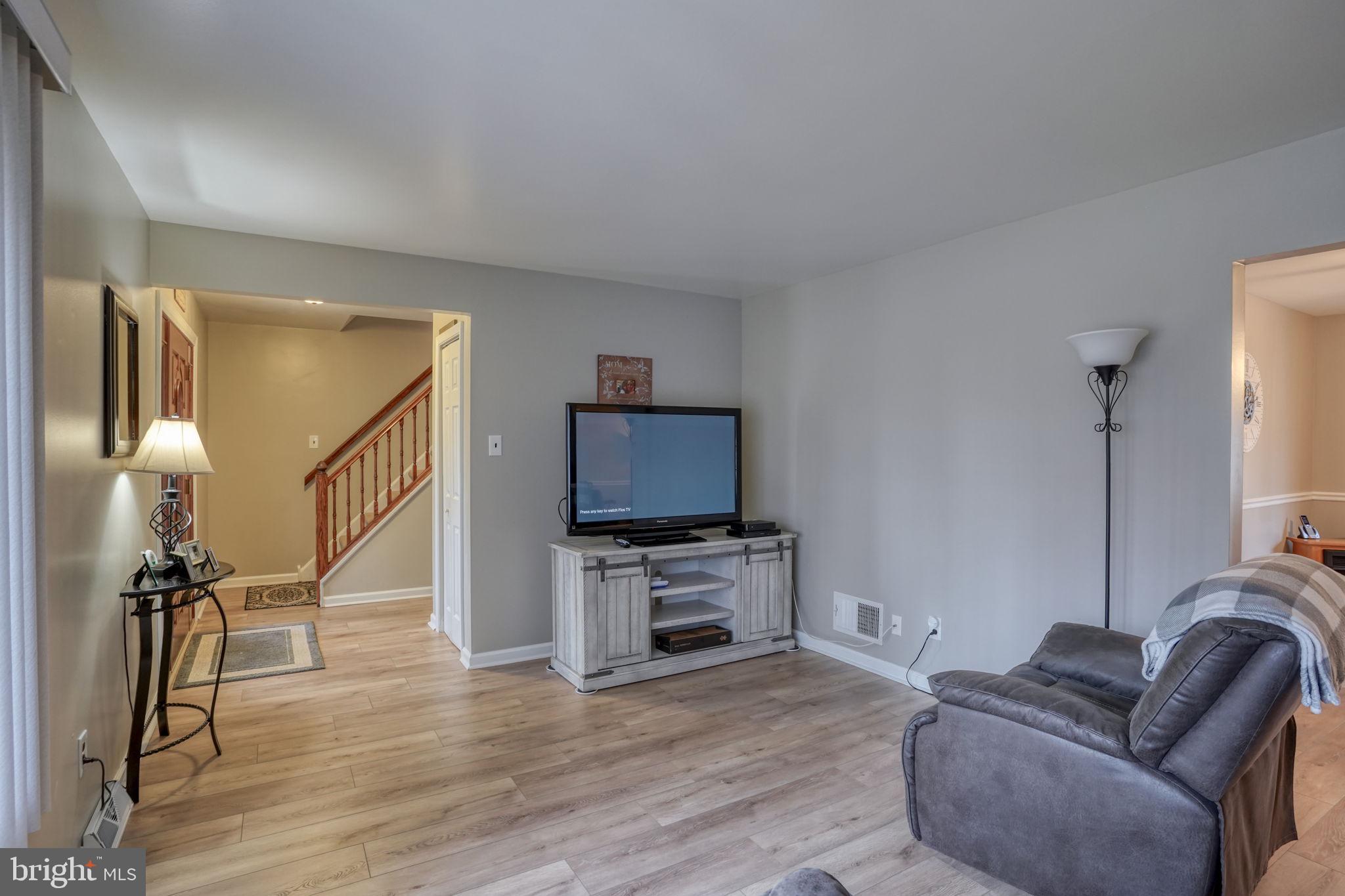 3850 Naamans Creek Road Upper Chichester, PA 19061 - Photo 8 of 53 a living room with furniture and a flat screen tv