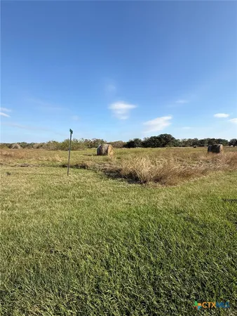 a view of a field with an ocean
