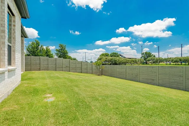 a view of an house with backyard space and balcony