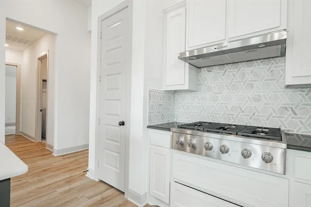 a white stove top oven sitting inside of a kitchen