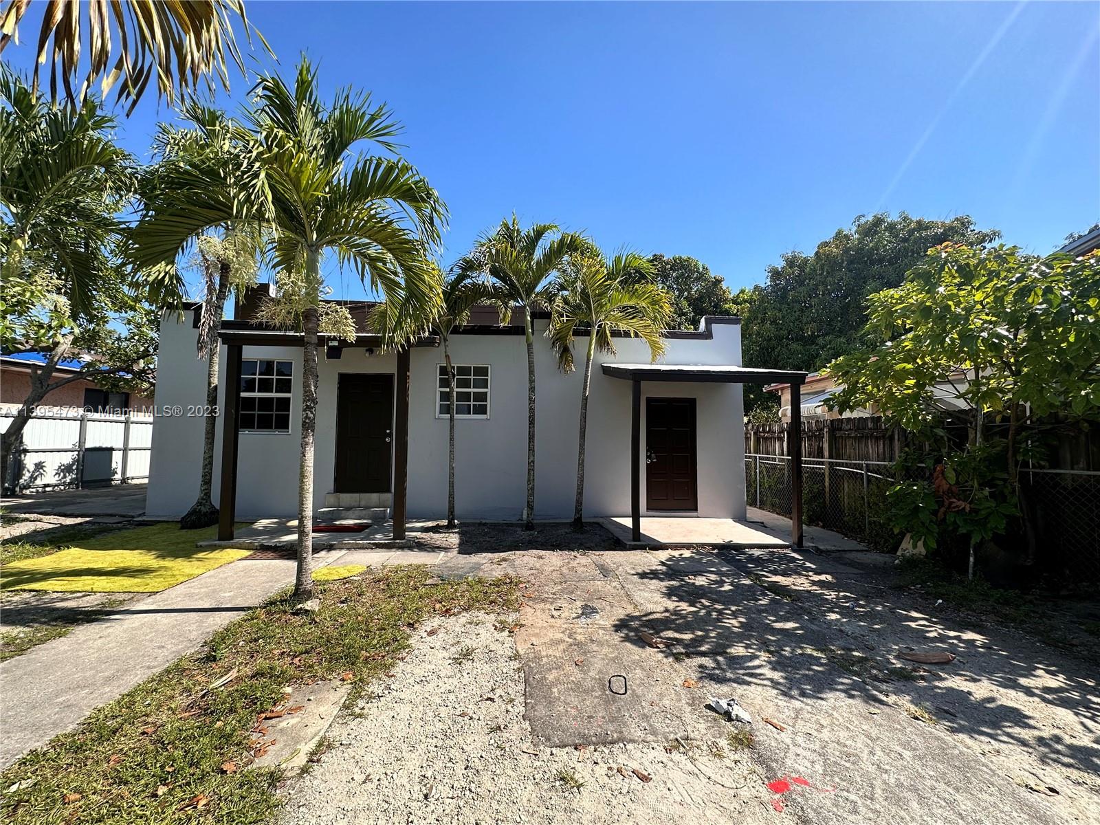276 East 12th Street Hialeah, FL 33010 - Photo 1 of 27 a front view of a house with a yard