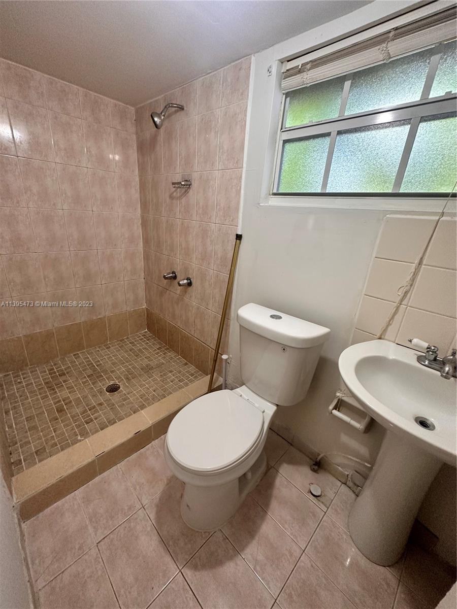 276 East 12th Street Hialeah, FL 33010 - Photo 12 of 27 a bathroom with a toilet sink and shower