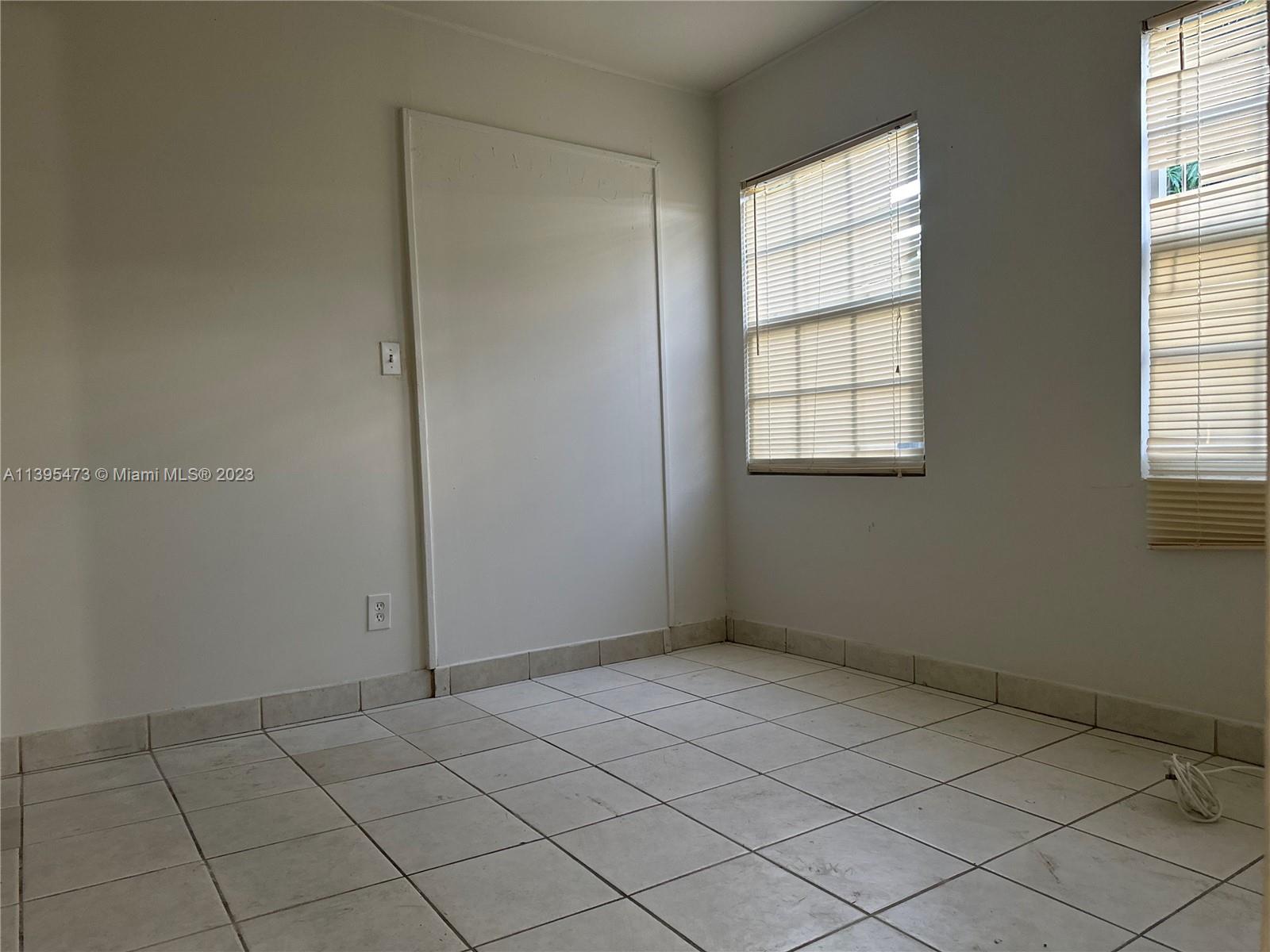 276 East 12th Street Hialeah, FL 33010 - Photo 15 of 27 an empty room with windows