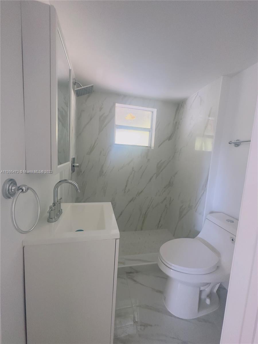 276 East 12th Street Hialeah, FL 33010 - Photo 21 of 27 a bathroom with a toilet sink and mirror