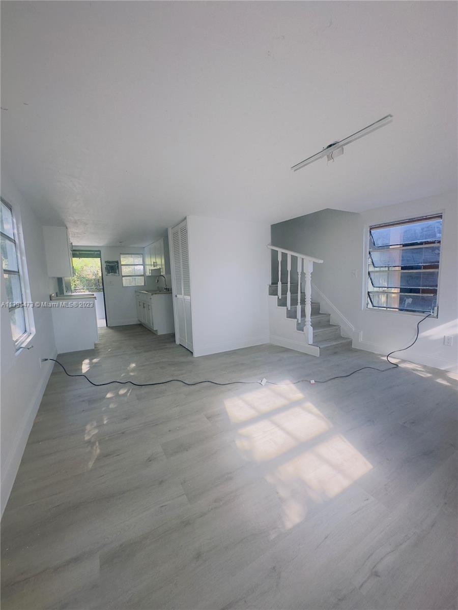 276 East 12th Street Hialeah, FL 33010 - Photo 22 of 27 a view of a big room with chandelier and windows