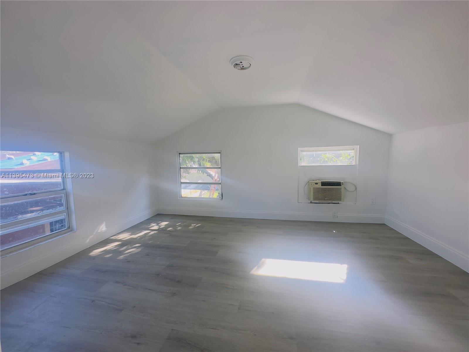 276 East 12th Street Hialeah, FL 33010 - Photo 25 of 27 an empty room with windows