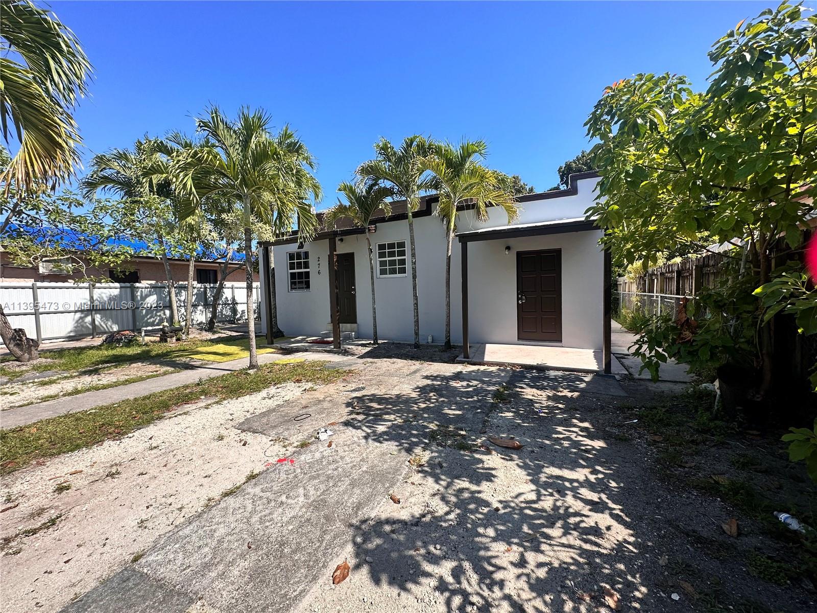 276 East 12th Street Hialeah, FL 33010 - Photo 3 of 27 a front view of a house with a yard