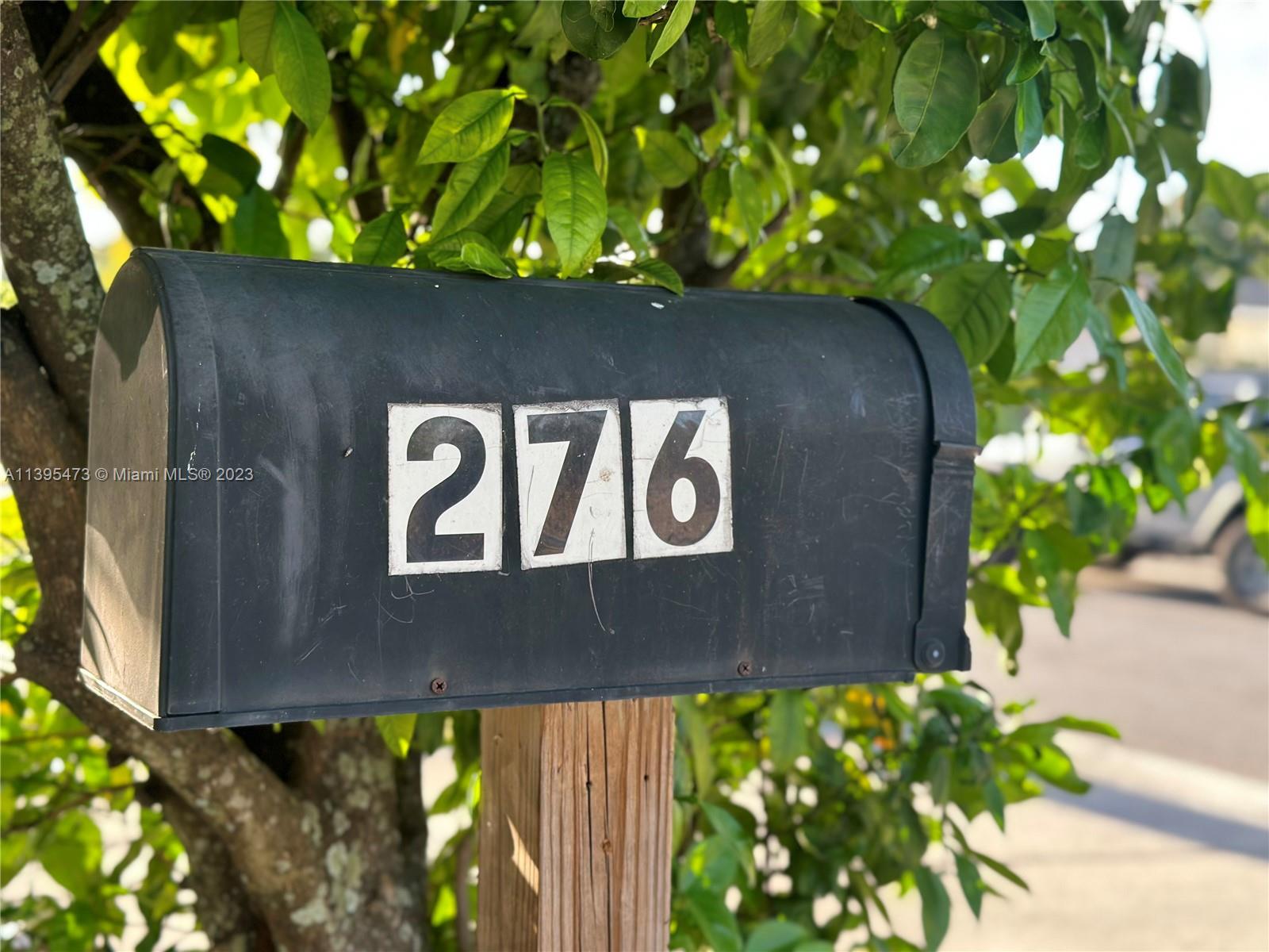 276 East 12th Street Hialeah, FL 33010 - Photo 4 of 27 a wooden door with a tree