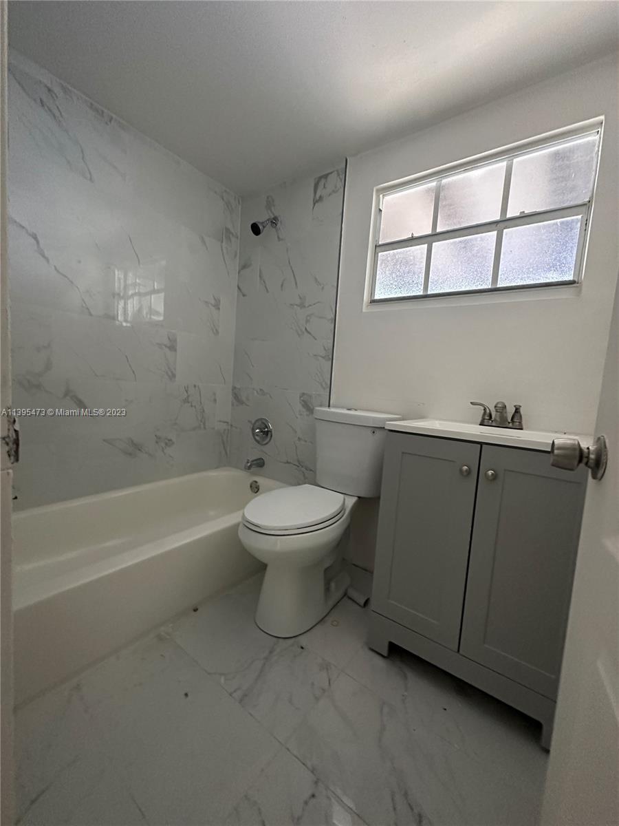 276 East 12th Street Hialeah, FL 33010 - Photo 8 of 27 a bathroom with a toilet a sink and bathtub