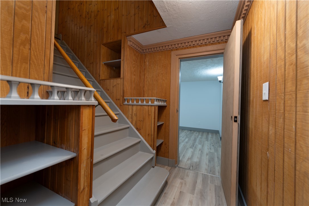 16535 Messenger Road Chagrin Falls, OH 44023 - Photo 30 of 37 Staircase leading to basement with wood floors leading to Bonus room