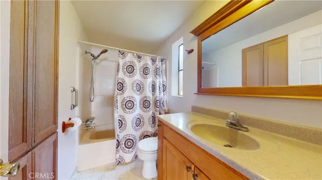 a view of a bedroom with wooden floor and cabinet