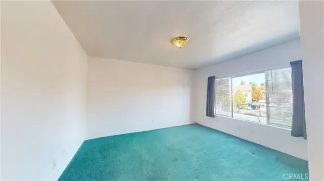 a view of room with window and ceiling fan
