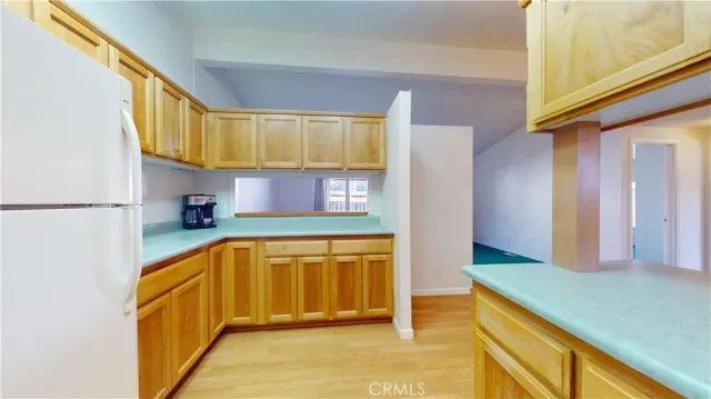 a kitchen with stainless steel appliances granite countertop a refrigerator a stove and a sink