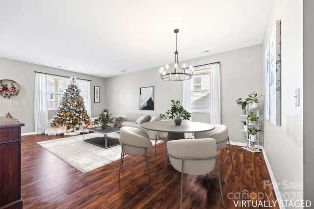 a spacious bedroom with a bed and a chandelier