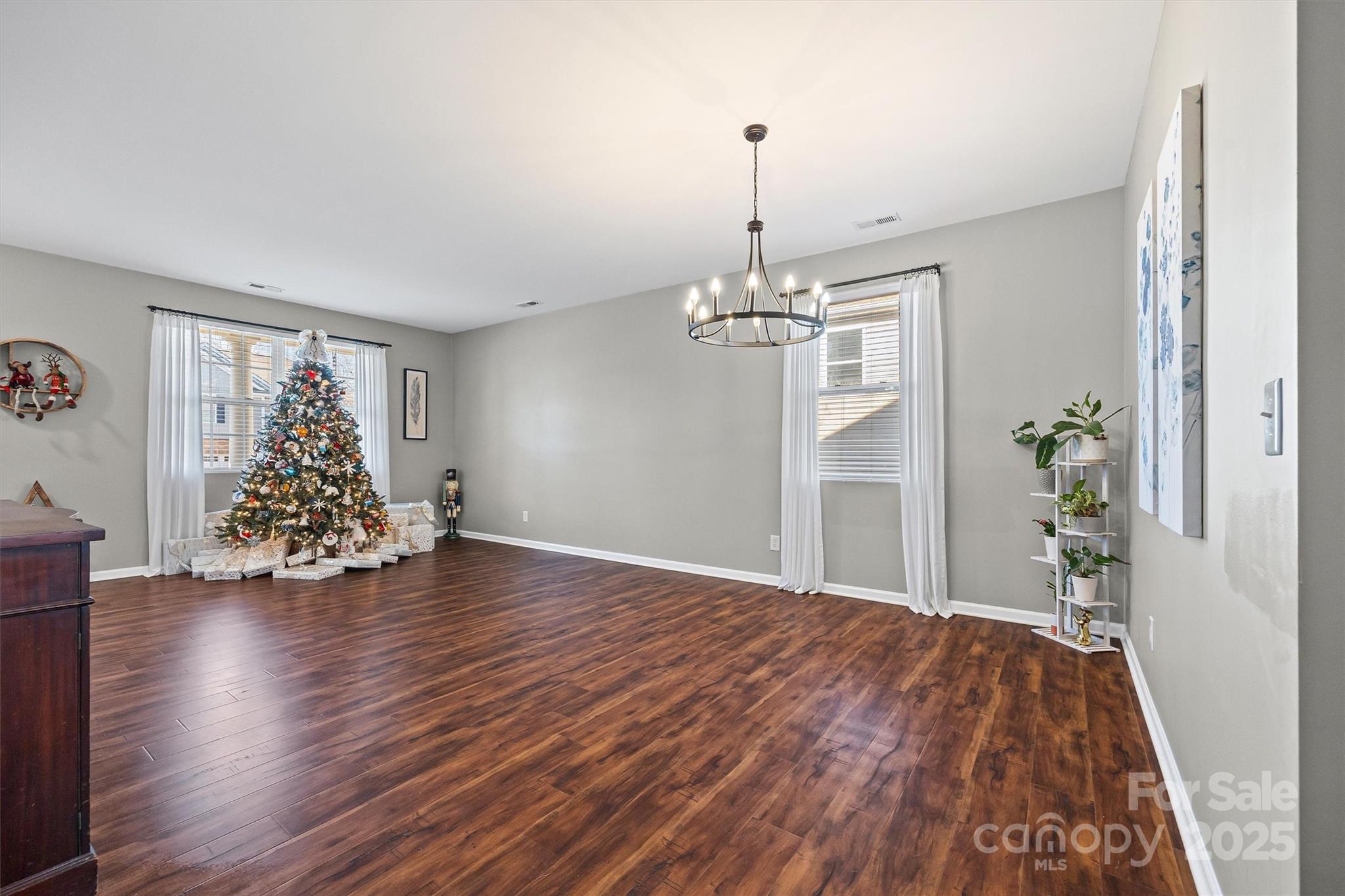 422 Garden Grove Road Fort Mill, SC 29708 - Photo 14 of 39 a view of a room with wooden floor staircase and a chandelier