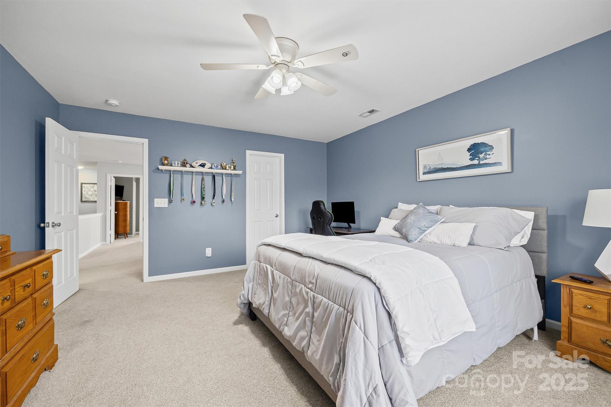 422 Garden Grove Road Fort Mill, SC 29708 - Photo 19 of 39 a spacious bedroom with a bed and a chandelier
