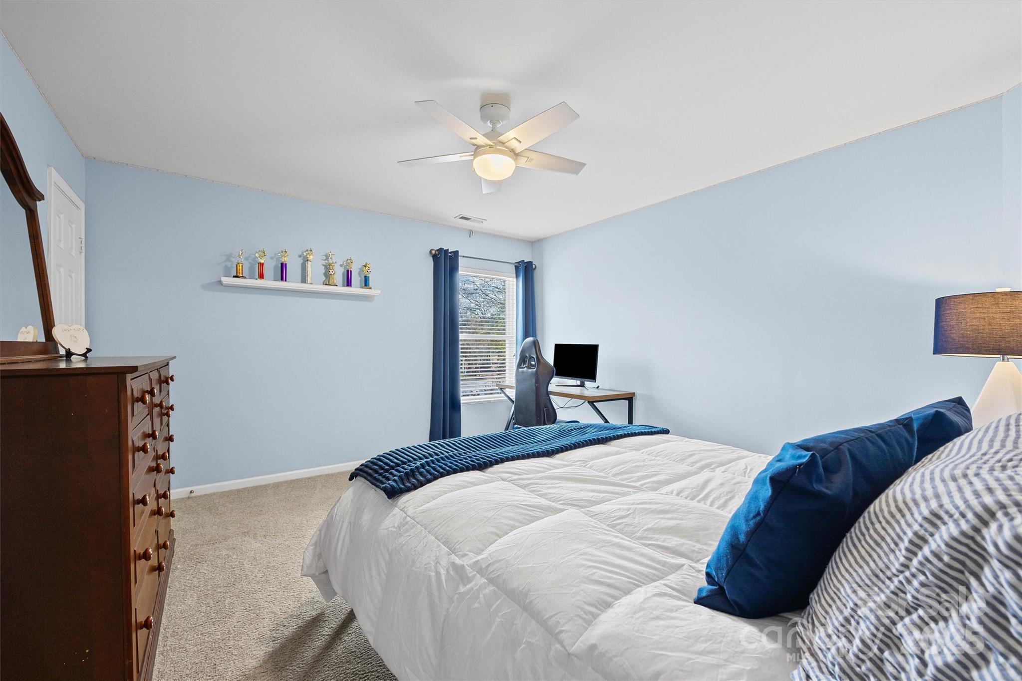 422 Garden Grove Road Fort Mill, SC 29708 - Photo 20 of 39 a bedroom with a bed and a chandelier