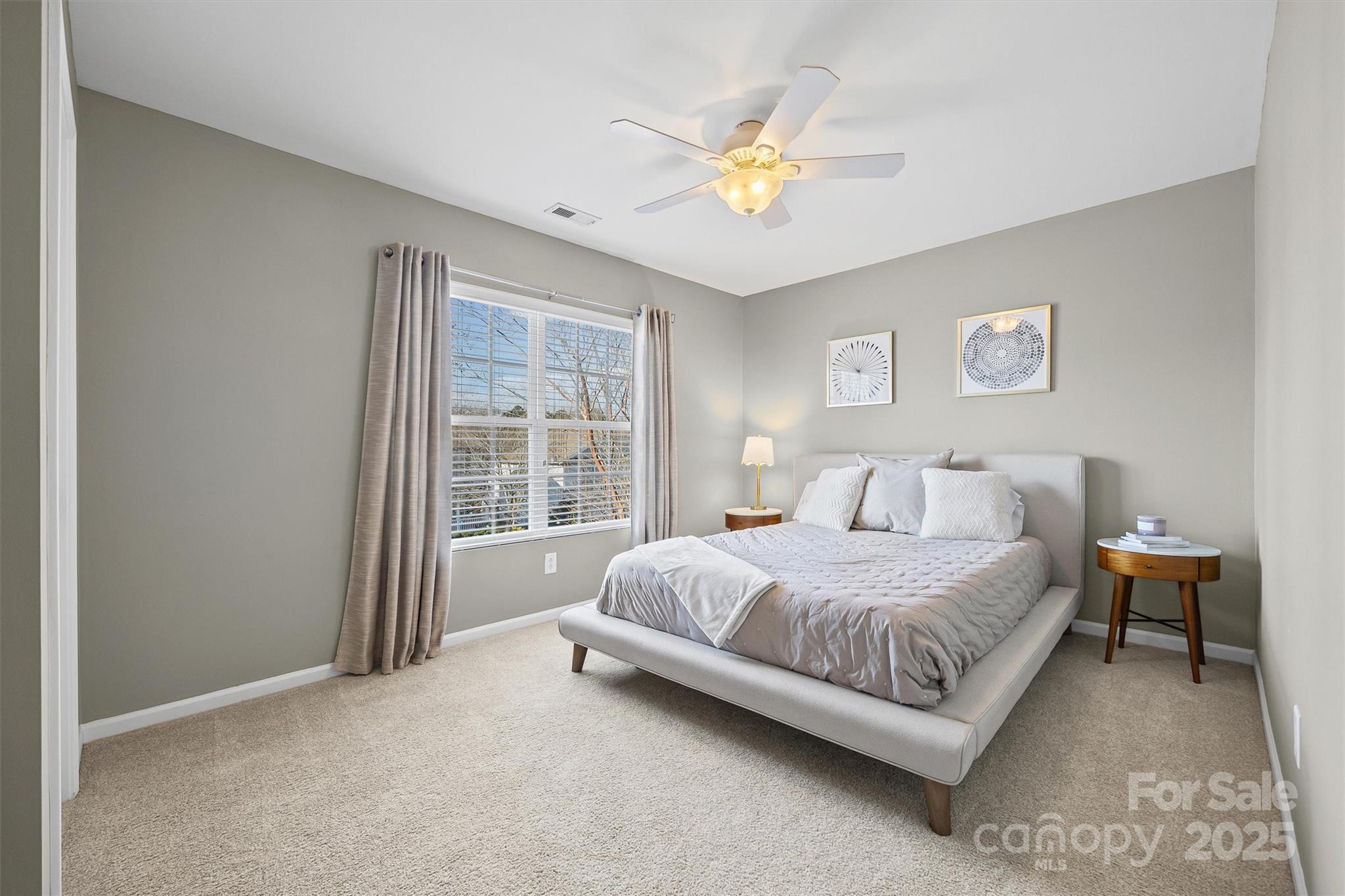 422 Garden Grove Road Fort Mill, SC 29708 - Photo 21 of 39 a bedroom with a bed and a chandelier