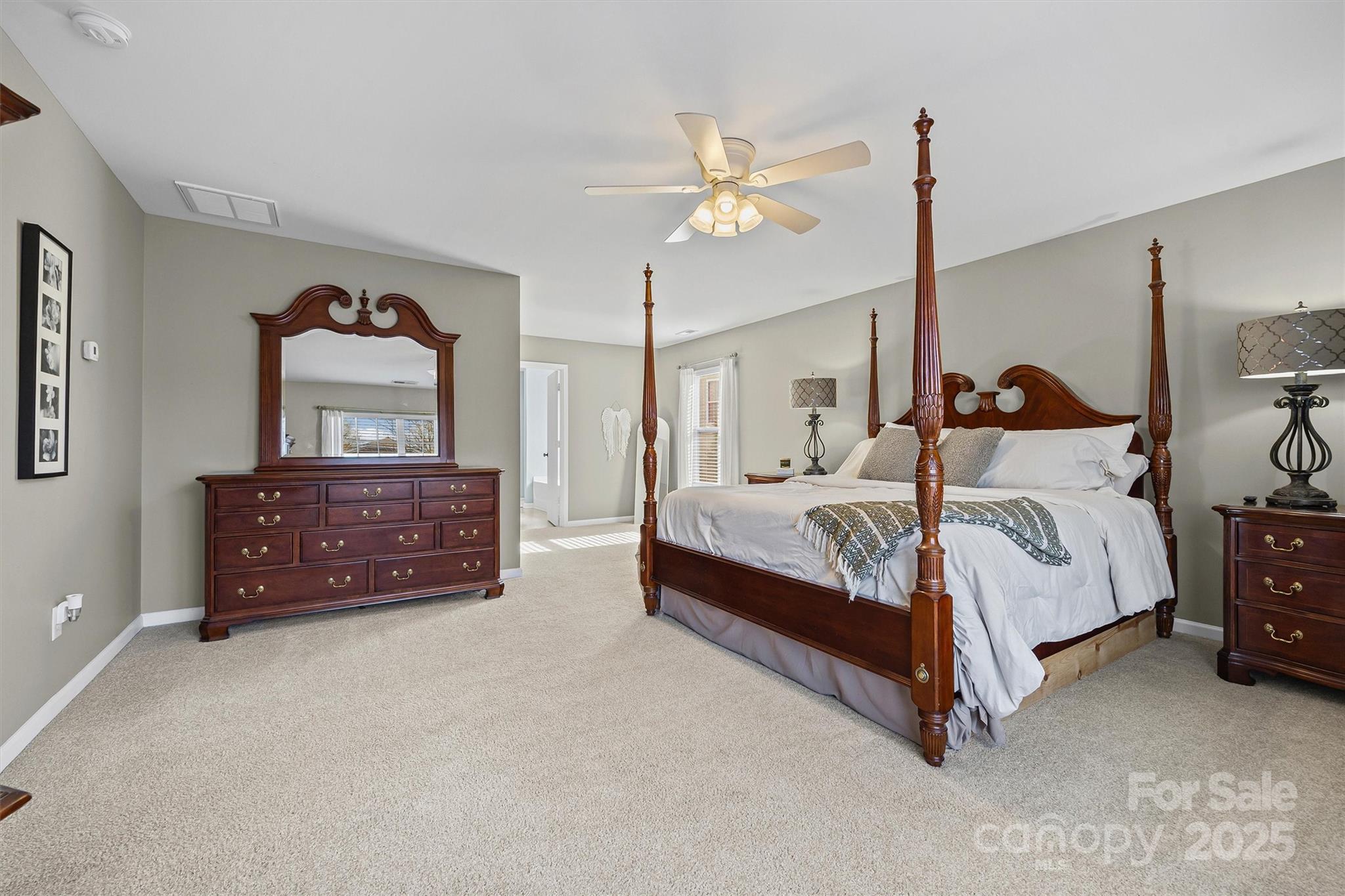 422 Garden Grove Road Fort Mill, SC 29708 - Photo 25 of 39 a bedroom with a bed and a chandelier