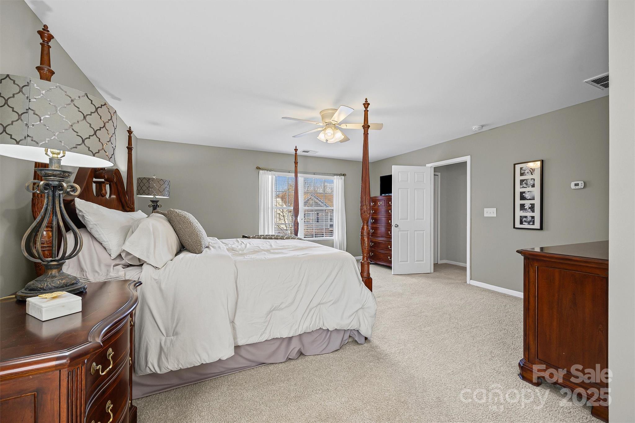 422 Garden Grove Road Fort Mill, SC 29708 - Photo 26 of 39 a spacious bedroom with a bed and a cabinets