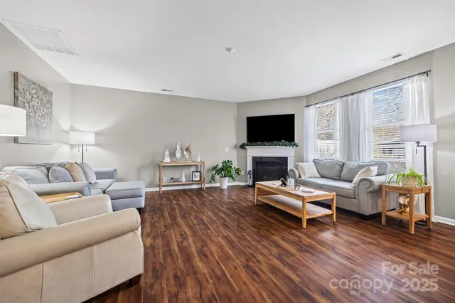 a living room with furniture flat screen tv and a fireplace