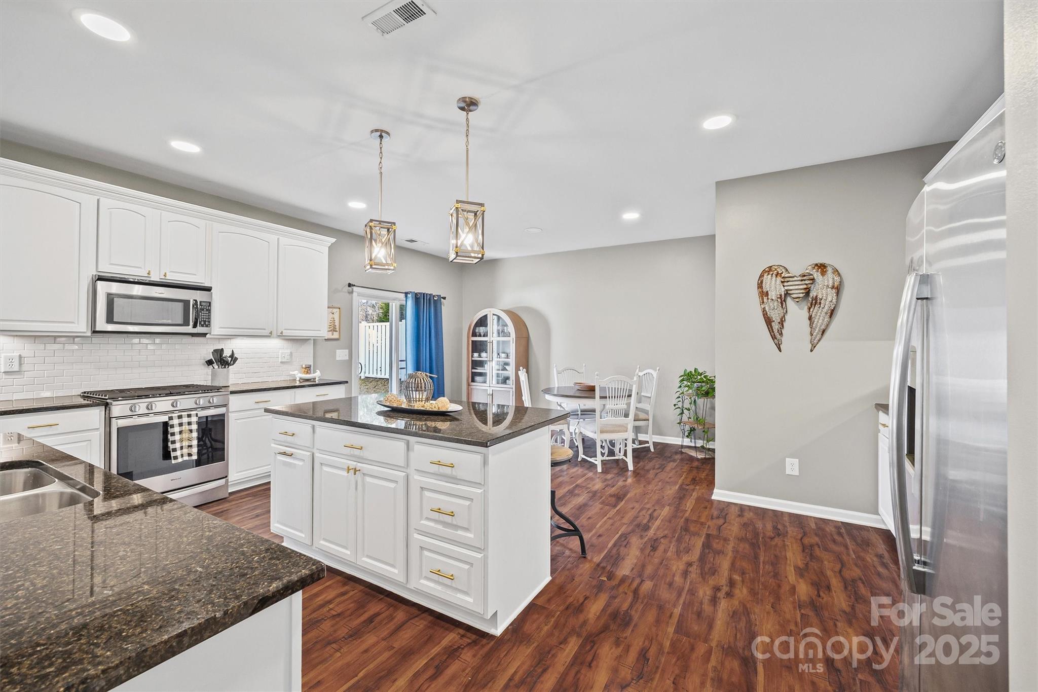 422 Garden Grove Road Fort Mill, SC 29708 - Photo 9 of 39 a kitchen with stainless steel appliances granite countertop a sink stove and refrigerator