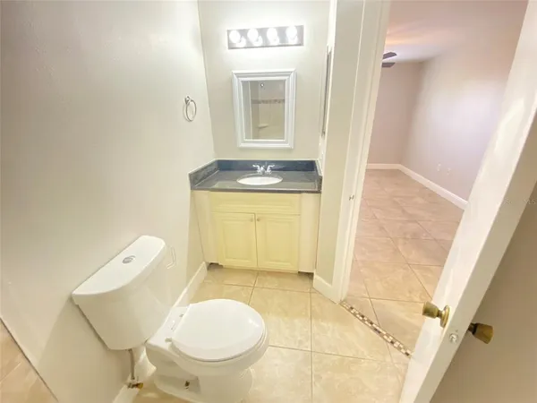 a bathroom with a sink a toilet and mirror
