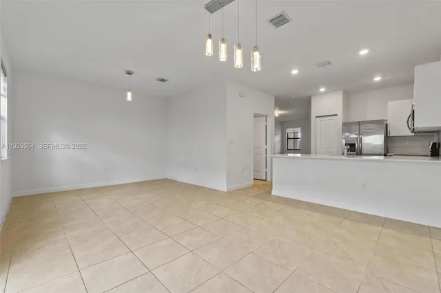 a view of a kitchen with a sink and a refrigerator