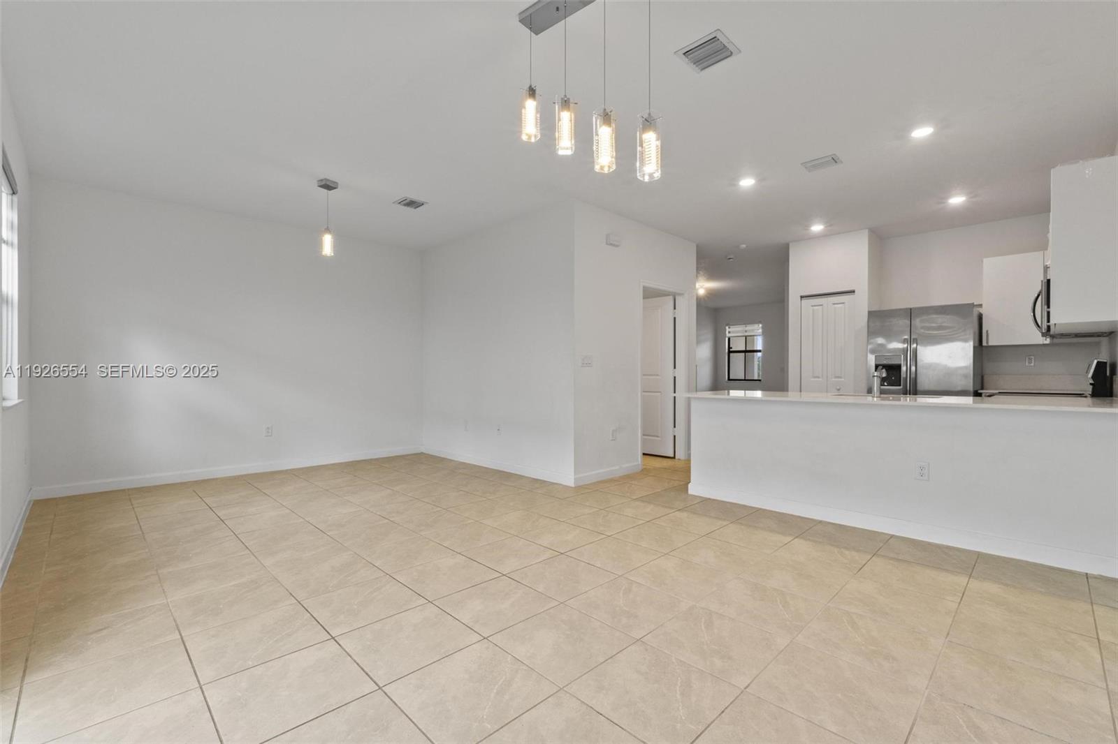 23016 Southwest 129th Court Miami, FL 33177 - Photo 15 of 39 a view of a kitchen with a sink and a refrigerator