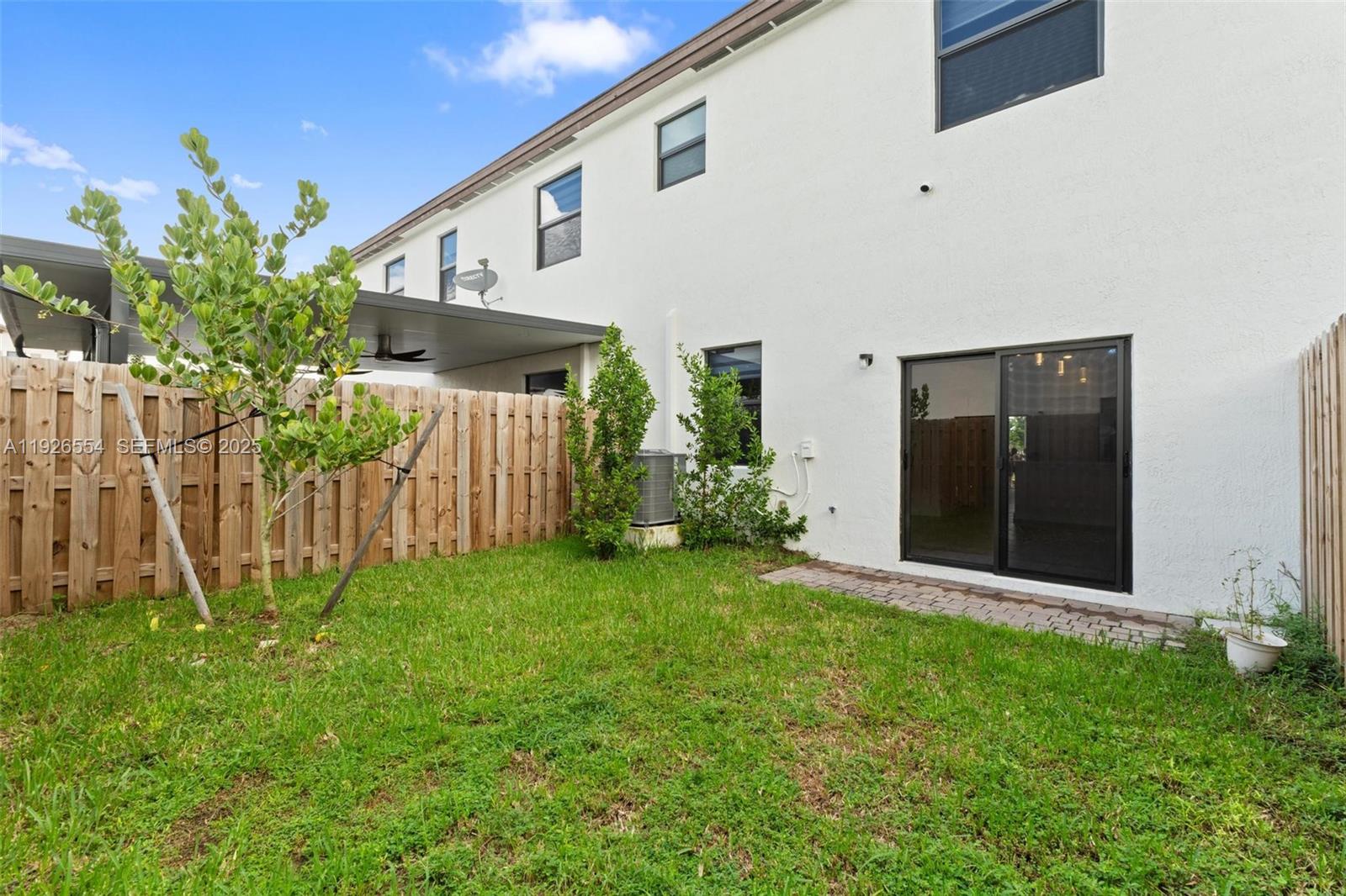 23016 Southwest 129th Court Miami, FL 33177 - Photo 18 of 39 a front view of a house with garden