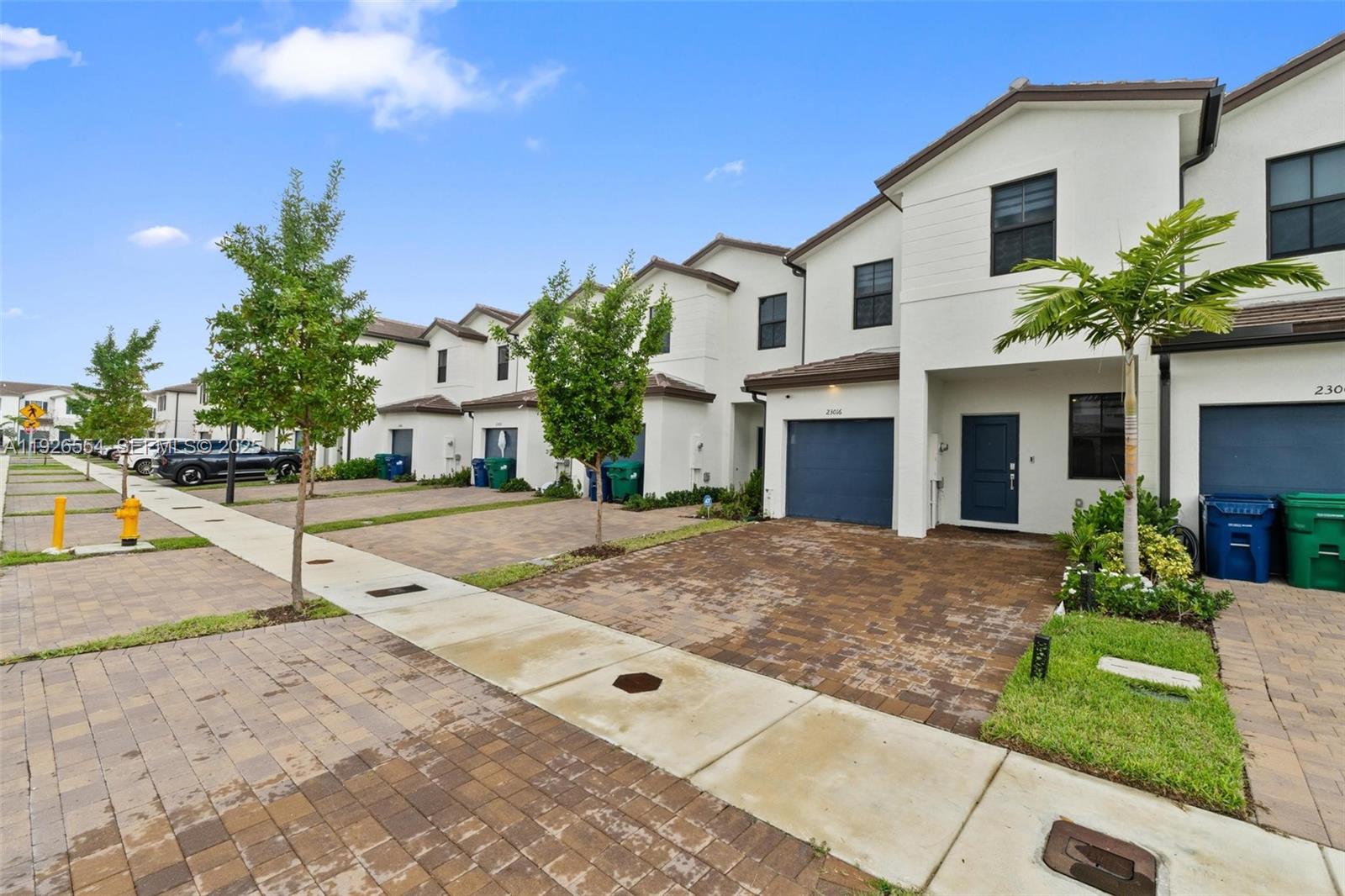 23016 Southwest 129th Court Miami, FL 33177 - Photo 3 of 39 a view of a white house with a yard and plants