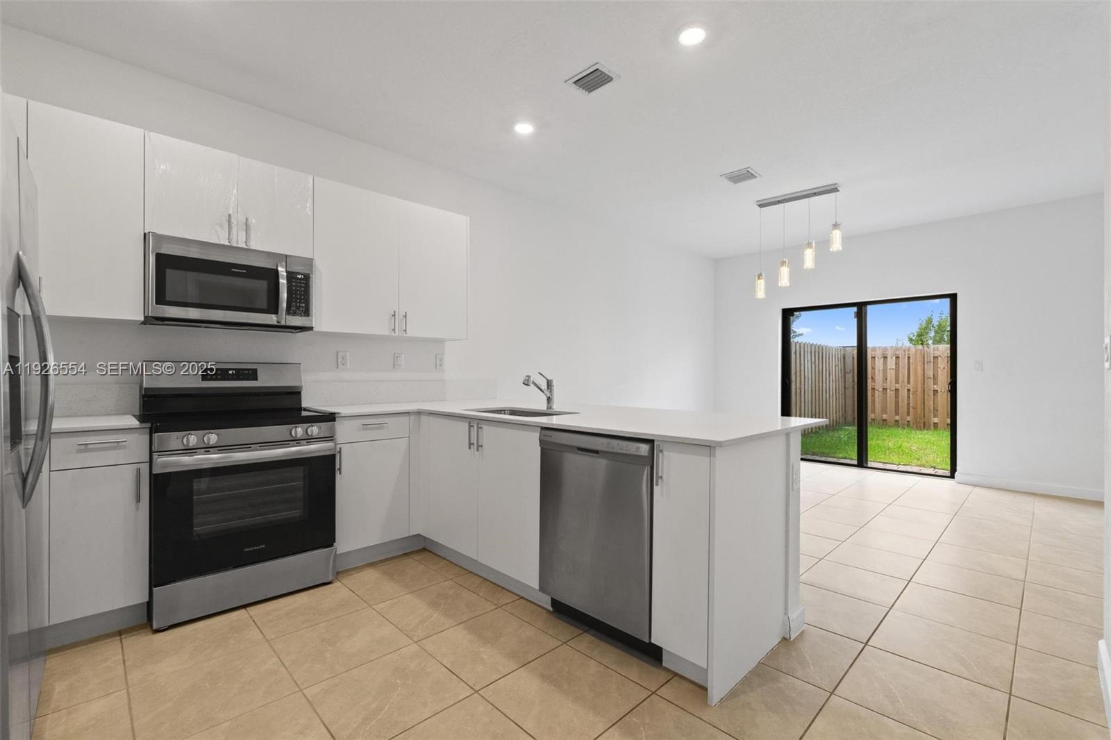 23016 Southwest 129th Court Miami, FL 33177 - Photo 8 of 39 a kitchen with stainless steel appliances granite countertop a refrigerator and a stove top oven