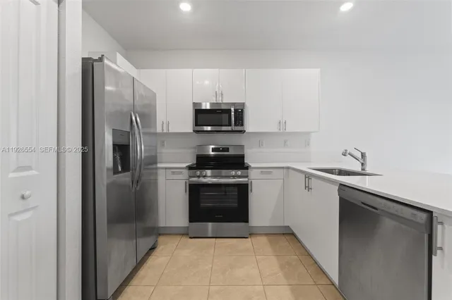 a kitchen with a sink and a stove top oven