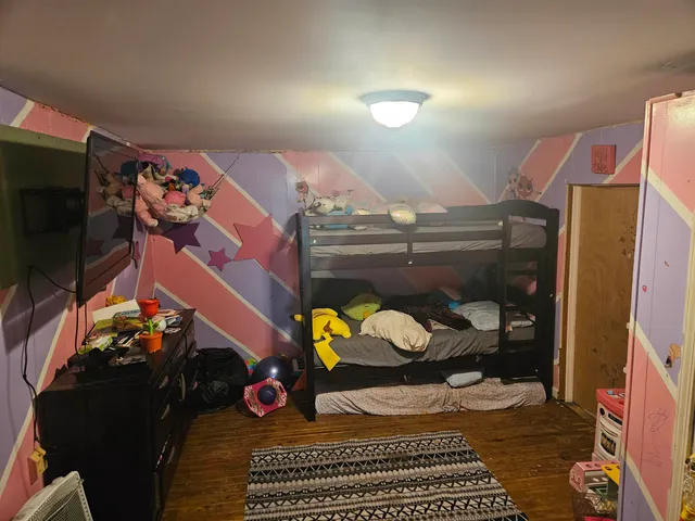 a bedroom with a bed and a dresser