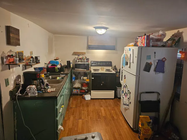 a kitchen with sink a refrigerator and a stove