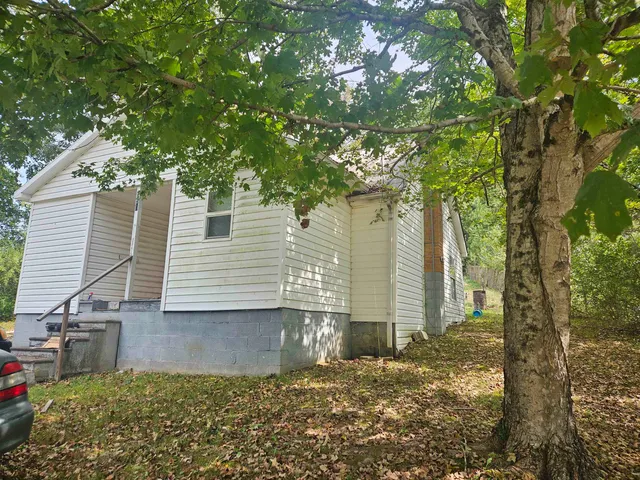 a view of a house with a tree