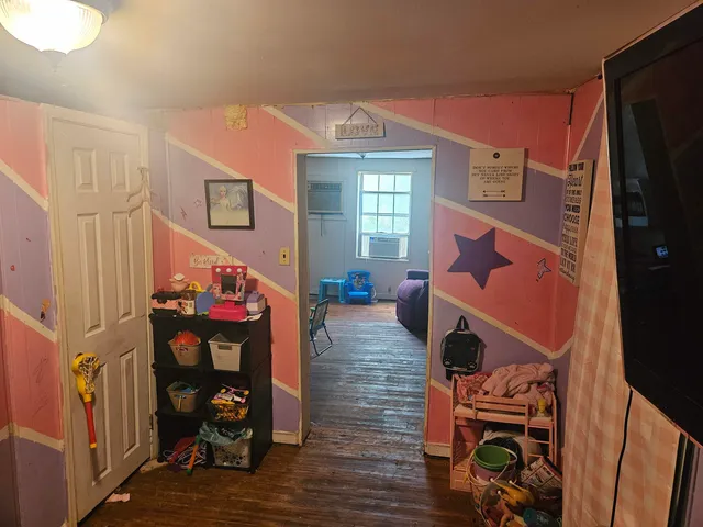 a living room with furniture a fireplace and wooden floor