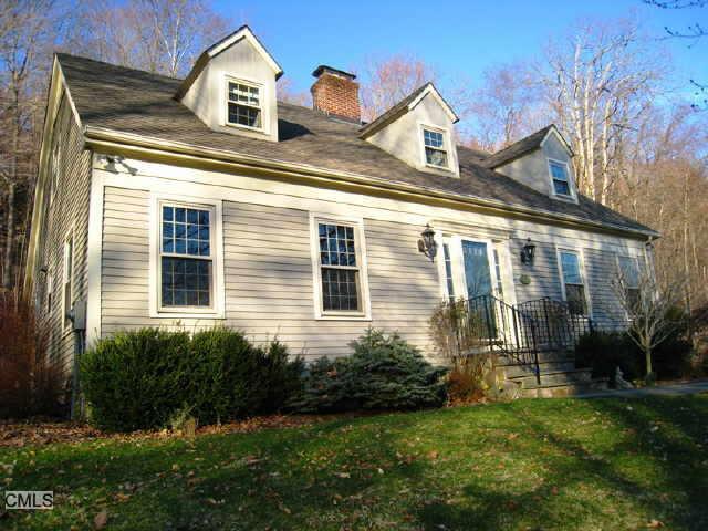 126 Ridgebury Road Ridgefield, CT 06877 - Photo 1 of 1 a front view of a house with a yard