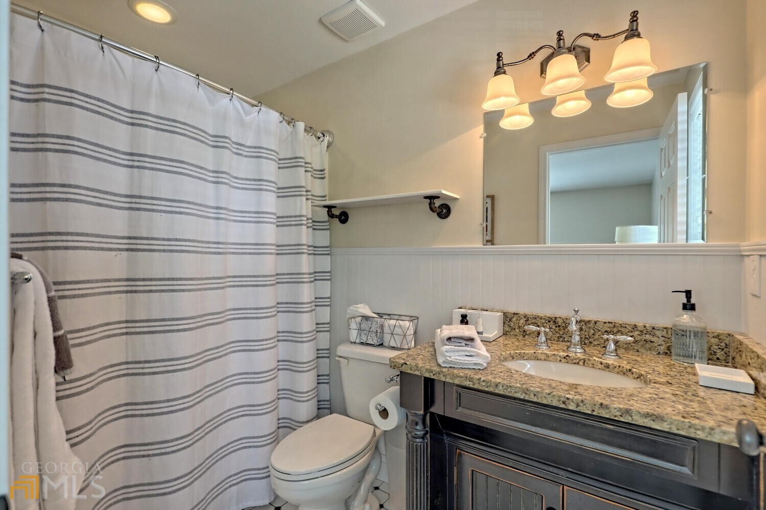 643 Washington Street Clarkesville, GA 30523 - Photo 43 of 56 a bathroom with a granite countertop sink mirror vanity and toilet