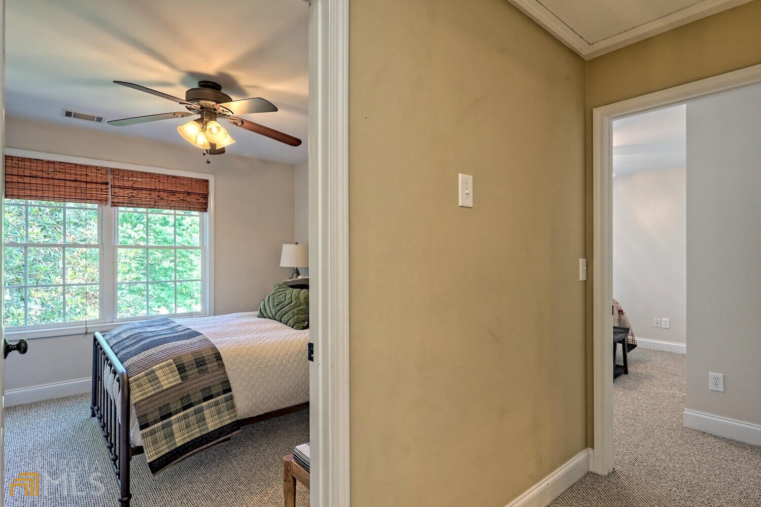 643 Washington Street Clarkesville, GA 30523 - Photo 47 of 56 a bedroom with a bed and a chandelier