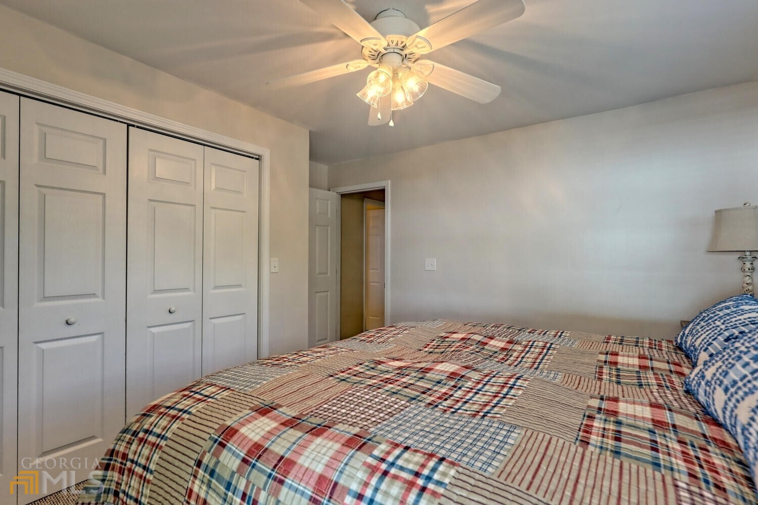 643 Washington Street Clarkesville, GA 30523 - Photo 54 of 56 a bedroom with a bed and a chandelier