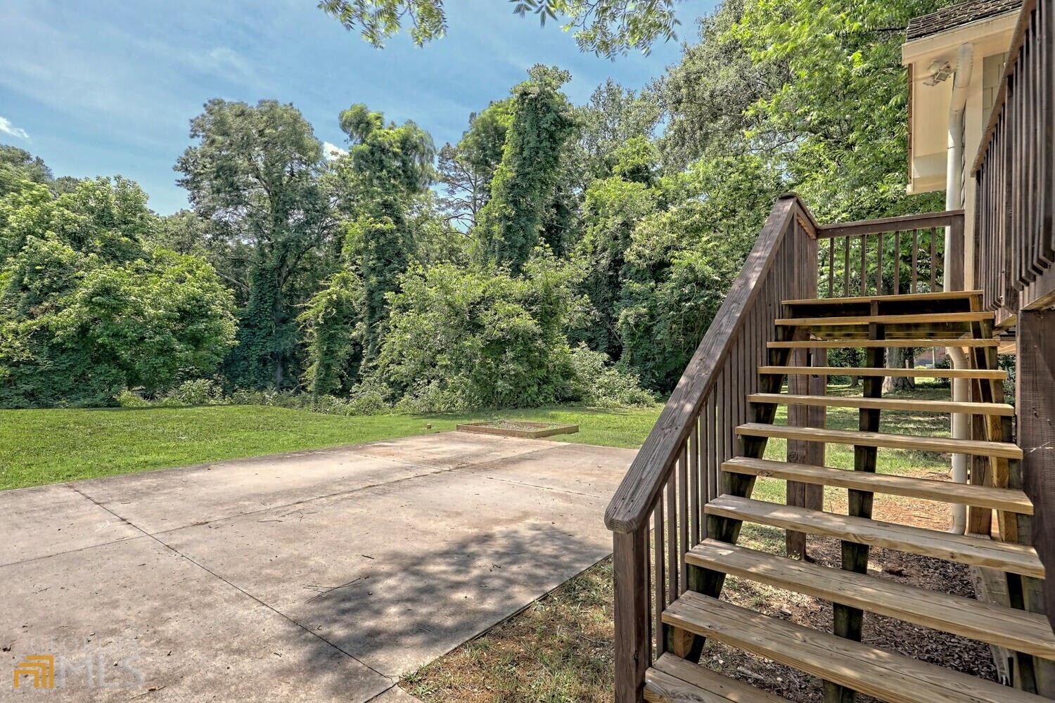 643 Washington Street Clarkesville, GA 30523 - Photo 7 of 56 a view of a backyard with dishwasher and wooden fence