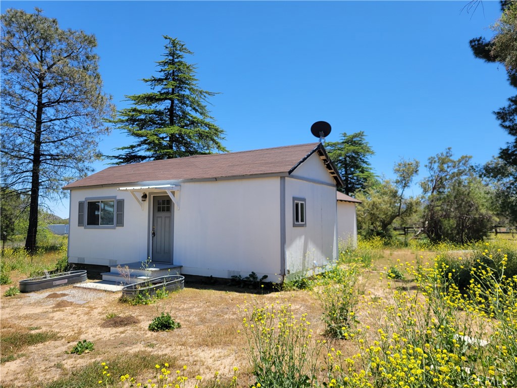 58804 Ramsey Road Anza, CA 92539 - Photo 41 of 51 a backyard of a house with potted plants and large tree