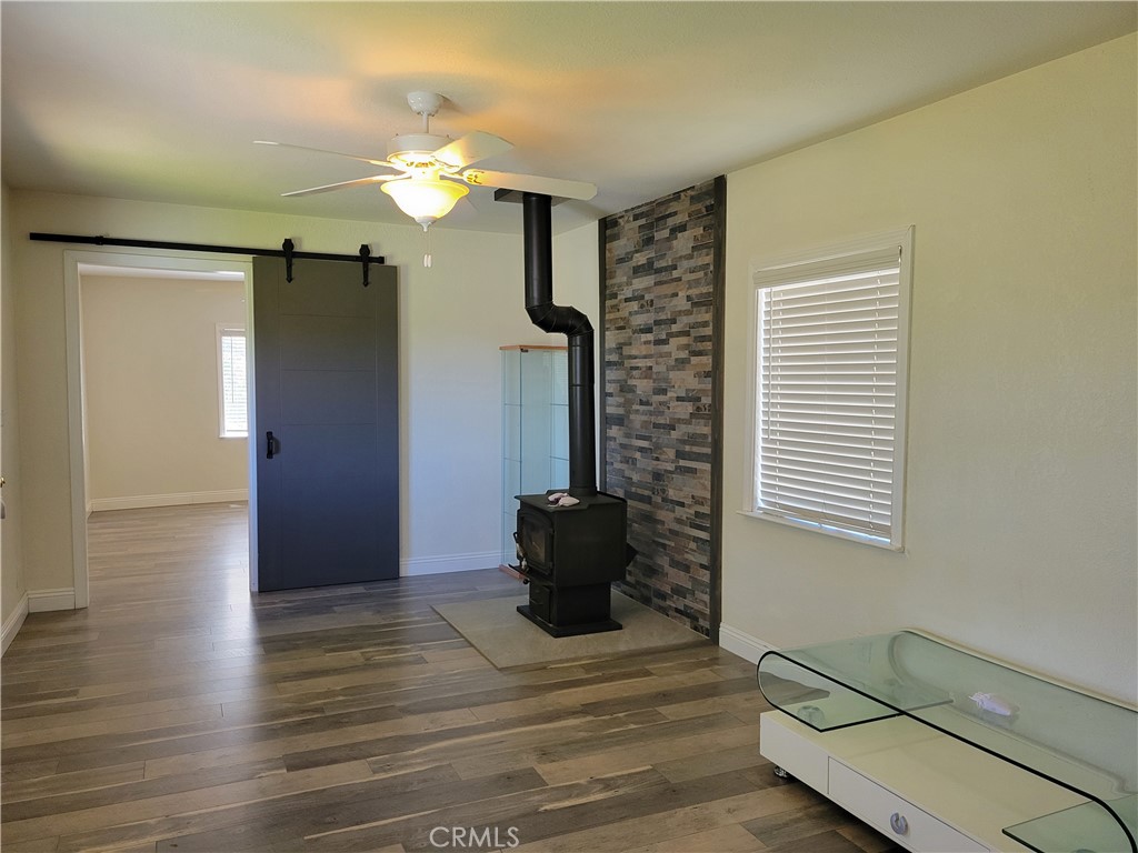 58804 Ramsey Road Anza, CA 92539 - Photo 46 of 51 a view of a livingroom with a ceiling fan and wooden floor