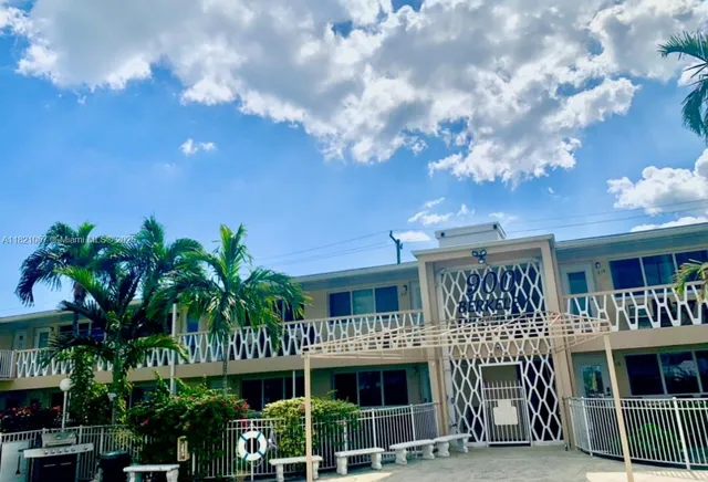a bath tub sitting next to a white toilet and a sink