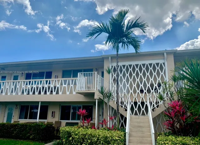 a bathroom with a double vanity sink and large mirror