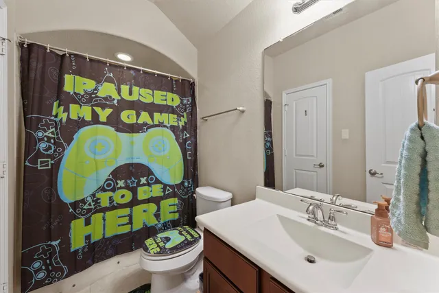 a bathroom with a toilet sink and mirror