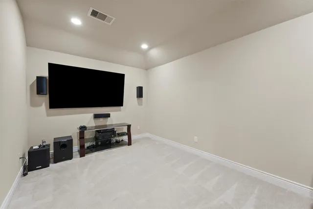 a living room with flat screen tv and a window