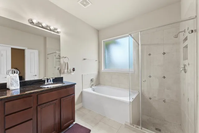 a bathroom with a tub a sink and mirrors